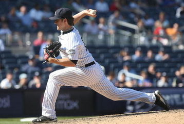NEW YORK - JUNE 14: Phil Hughes #65 of the New York Yankees pitches against the New York Mets on June 14, 2009 at Yankee Stadium in the Bronx borough of New York City.  (Photo by Nick Laham/Getty Images)