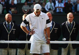 WIMBLEDON, ENGLAND - JULY 05:  Andy Roddick of USA looks despondent after defeat during the men's singles final match against Roger Federer of Switzerland on Day Thirteen of the Wimbledon Lawn Tennis Championships at the All England Lawn Tennis and Croquet Club on July 5, 2009 in London, England. Federer won 5-7, 7-6, 7-6, 3-6, 16-14.  (Photo by Clive Brunskill/Getty Images)