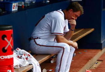 ATLANTA - JUNE 27:  Chipper Jones #10 of the Atlanta Braves sits dejected in the dugout after falling to the Boston Red Sox 1-0 at Turner Field on June 27, 2009 in Atlanta, Georgia.  (Photo by Kevin C. Cox/Getty Images)