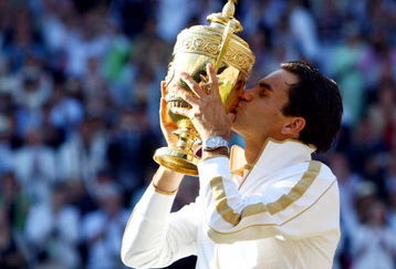 WIMBLEDON, ENGLAND - JULY 05:  Roger Federer of Switzerland kisses the trophy after victory during the men's singles final match against Andy Roddick of USA on Day Thirteen of the Wimbledon Lawn Tennis Championships at the All England Lawn Tennis and Croquet Club on July 5, 2009 in London, England. Federer won 5-7, 7-6, 7-6, 3-6, 16-14.  (Photo by Clive Brunskill/Getty Images)