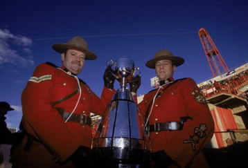 26 Nov 2000:  A view of two Mounties posing with the Grey Cup before the Grey Cup 2000 game between the British Columbia Lions and the Montreal Alouettes at the McMahon Stadium in Calgary, Alberta, Canada. The Lions defeated the Alouettes 28-26. Mandatory Credit: Craig Klem  /Allsport