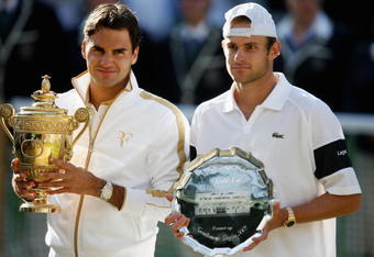 WIMBLEDON, ENGLAND - JULY 05:  Roger Federer of Switzerland and Andy Roddick of USA pose for photographers after the men's singles final match against  on Day Thirteen of the Wimbledon Lawn Tennis Championships at the All England Lawn Tennis and Croquet Club on July 5, 2009 in London, England. Federer won 5-7, 7-6, 7-6, 3-6, 16-14.  (Photo by Paul Gilham/Getty Images)