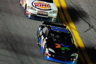DAYTONA BEACH, FL - JULY 04:  Denny Hamlin, driver of the #11 FedEx Office Toyota, leads Tony Stewart, driver of the #14 Burger King Chevrolet,  Kyle Busch, driver of the #18 Interstate Batteries Toyota, during the NASCAR Sprint Cup Series 51st Annual Coke Zero 400 at Daytona International Speedway on July 4, 2009 in Daytona Beach, Florida.  (Photo by Sam Greenwood/Getty Images)