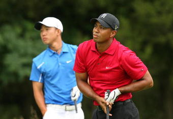 BETHESDA, MD - JULY 5 : Tiger Woods watches his tee shot on the sixth hole as Anthony Kim looks on during the final round of the AT&T National hosted by Tiger Woods at Congressional Country Club on July 5, 2009 in Bethesda, Maryland. (Photo by Hunter Martin/Getty Images)
