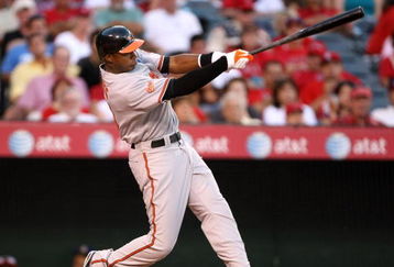 ANAHEIM, CA - JULY 4:    Adam Jones #10 of the Baltimore Orioles hits an RBI single in the fifth ining against the Los Angeles Angels of Anaheim on July 4, 2009 at Angel Stadium in Anaheim, California.    (Photo by Stephen Dunn/Getty Images)