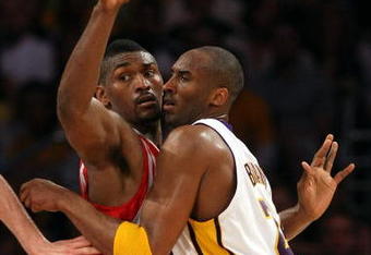 LOS ANGELES, CA - MAY 17:  Kobe Bryant #24 of the Los Angeles Lakers is covered by Ron Artest #96 of the Houston Rockets in the third quarter of Game Seven of the Western Conference Semifinals during the 2009 NBA Playoffs at Staples Center on May 17, 2009 in Los Angeles, California. NOTE TO USER: User expressly acknowledges and agrees that, by downloading and or using this photograph, User is consenting to the terms and conditions of the Getty Images License Agreement.  (Photo by Stephen Dunn/Getty Images)