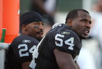 OAKLAND, CA - NOVEMBER 2:  Michael Huff #24 and Sam Williams #54 of the Oakland Raiders look on from the bench area during the game against the the Atlanta Falcons on November 2, 2008 at the Oakland-Alameda County Coliseum in Oakland, California. The Falcons defeated the Raiders 24-0. (Photo by Jed Jacobsohn/Getty Images)