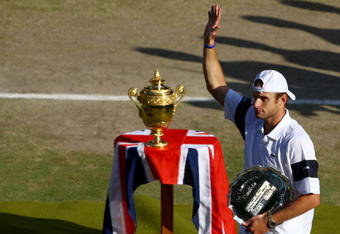 WIMBLEDON, ENGLAND - JULY 05:  Andy Roddick of USA waves to the crowd after defeat during the men's singles final match against Roger Federer of Switzerland on Day Thirteen of the Wimbledon Lawn Tennis Championships at the All England Lawn Tennis and Croquet Club on July 5, 2009 in London, England. Federer won 5-7, 7-6, 7-6, 3-6, 16-14.  (Photo by Julian Finney/Getty Images)