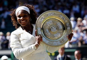 WIMBLEDON, ENGLAND - JULY 04:  Serena Williams of USA celebrates with the Championship trophy after the women's singles final match against Venus Williams of USA on Day Twelve of the Wimbledon Lawn Tennis Championships at the All England Lawn Tennis and Croquet Club on July 4, 2009 in London, England. Serena Williams of USA won 7-6, 6-2.  (Photo by Hamish Blair/Getty Images)