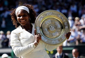 WIMBLEDON, ENGLAND - JULY 04:  Serena Williams of USA celebrates with the Championship trophy after the women's singles final match against Venus Williams of USA on Day Twelve of the Wimbledon Lawn Tennis Championships at the All England Lawn Tennis and Croquet Club on July 4, 2009 in London, England. Serena Williams of USA won 7-6, 6-2.  (Photo by Hamish Blair/Getty Images)