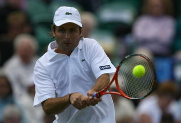 EASTBOURNE, ENGLAND - JUNE 19:  Fabrice Santoro of France plays a backhand against Frank Dancevic of Canada during day five of the AEGON International on June 19, 2009 in Eastbourne, England.  (Photo by Julian Finney/Getty Images)