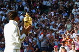 WIMBLEDON, ENGLAND - JULY 05:  Roger Federer of Switzerland celebrates victory with the trophy after the men's singles final match against Andy Roddick of USA on Day Thirteen of the Wimbledon Lawn Tennis Championships at the All England Lawn Tennis and Croquet Club on July 5, 2009 in London, England. Federer won 5-7, 7-6, 7-6, 3-6, 16-14.  (Photo by Clive Brunskill/Getty Images)