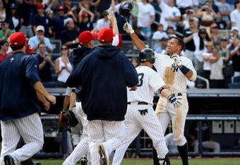 NEW YORK - JULY 04: Alex Rodriguez #13 of the New York Yankees celebrates scoring the winning run in the 12th inning after a Jorge Posada #20 single against the Toronto Blue Jays on July 4, 2009 at Yankee Stadium in the Bronx borough of New York City.  (Photo by Nick Laham/Getty Images)
