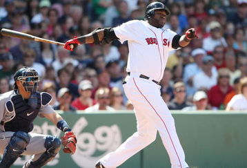 BOSTON - JULY 05:  David Ortiz #34 of the Boston Red Sox hits an RBI single in the seventh inning as Kenji Johjima #2 of the Seattle Mariners defends on July 5, 2009 at Fenway Park in Boston, Massachusetts. The Red Sox defeated the Mariners 8-4.  (Photo by Elsa/Getty Images)