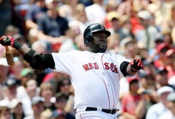 BOSTON - JULY 05:  David Ortiz #34 of the Boston Red Sox hits a solo home run in the first inning against the Seattle Mariners on July 5, 2009 at Fenway Park in Boston, Massachusetts.  (Photo by Elsa/Getty Images)