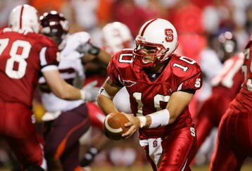 RALEIGH, NC - SEPTEMBER 4:  Quarterback Jay Davis #10 of the North Carolina State University Wolfpack hands-off the ball against the Virginia Polytechnic Institute and State University Hokies at Carter-Finley Stadium on September 4, 2005 in Raleigh, North Carolina.  Virginia Tech won 20-16.  (Photo by Streeter Lecka/Getty Images)
