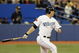 TORONTO - APRIL 6:  Adam Lind #26 of the Toronto Blue Jays swings at the pitch during the Opening Day game against the Detroit Tigers at the Rogers Centre on April 6, 2009 in Toronto, Ontario. (Photo by: Dave Sandford/Getty Images)