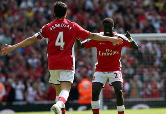 LONDON - APRIL 26:  Cesc Fabregas of Arsenal celebrates with his team mate Emmanuel Eboue after Fabregas scored the second goal during the Barclays Premier League match between Arsenal and Middlesbrough at Emirates Stadium on April 26, 2009 in London, England.  (Photo by Hamish Blair/Getty Images)