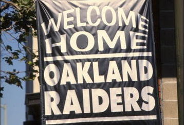 12 Aug 1995:  A local real estate business shows their support for the Raiders return to Oakland by hanging a banner outside the office during the Raiders 27-22 victory over the St. Louis Rams at the Oakland Alameda County Coliseum in Oakland, California.