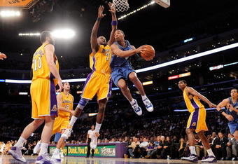 LOS ANGELES, CA - JANUARY 22:  Javaris Crittenton #8 of the Washington Wizards looks to pass against the defense of Lamar Odom #7 of the Los Angeles Lakers during the fourth quarter at the Staples Center January 22, 2009 in Los Angeles, California. NOTE TO USER: User expressly acknowledges and agrees that, by downloading and/or using this Photograph, user is consenting to the terms and conditions of the Getty Images License Agreement.  (Photo by Kevork Djansezian/Getty Images)