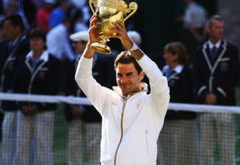 WIMBLEDON, ENGLAND - JULY 05:  Roger Federer of Switzerland celebrates victory with the trophy after the men's singles final match against Andy Roddick of USA on Day Thirteen of the Wimbledon Lawn Tennis Championships at the All England Lawn Tennis and Croquet Club on July 5, 2009 in London, England. Federer won 5-7, 7-6, 7-6, 3-6, 16-14.  (Photo by Paul Gilham/Getty Images)