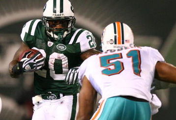 EAST RUTHERFORD, NJ - DECEMBER 28:  Thomas Jones #20 of The New York Jets runs the ball as Akin Ayodele #51 of The Miami Dolphins attempts the tackle during their game on December 28, 2008 at Giants Stadium in East Rutherford, New Jersey.  (Photo by Al Bello/Getty Images)