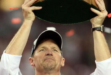 GLENDALE, AZ - JANUARY 18:  Head coach Ken Whisenhunt holds up the George S. Halas trophy after winning the NFC championship game against the Philadelphia Eagles on January 18, 2009 at University of Phoenix Stadium in Glendale, Arizona. The Cardinals defeated the Eagles 32-25 to advance to the Super Bowl.  (Photo by Jed Jacobsohn/Getty Images)
