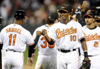 BALTIMORE - APRIL 06:  Adam Jones #10 of the Baltimore Orioles celebrates with Juan Samuel #11 after a 10-5 victory against the New York Yankees during opening day on April 6, 2009 at Camden Yards in Baltimore, Maryland.  (Photo by Greg Fiume/Getty Images)