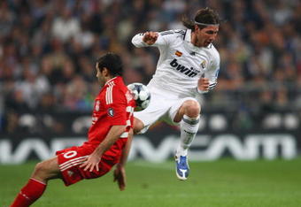 MADRID, SPAIN - FEBRUARY 25:  Carlos Mascherano of Liverpool tackles Sergio Ramos of Real Madrid during the Champions League Round of 16, First Leg match between Real Madrid and Liverpool at the Estadio Santiago Bernabeu on February 25, 2009 in Madrid, Spain.  (Photo by Clive Brunskill/Getty Images)