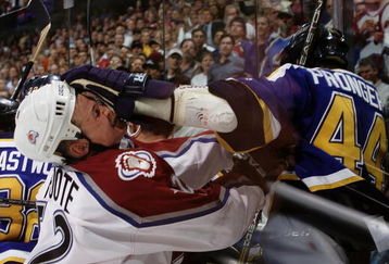14 May 2001:  Chris Pronger #44 of the St. Louis Blues puts a glove to the face of Adam Foote #52 of the Colorado Avalanche in the second period during game two of the Western Conference Finals at the Pepsi Center in Denver, Colorado.   DIGITAL IMAGE Mandatory Credit: Brian Bahr/ALLSPORT