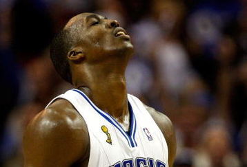 ORLANDO, FL - JUNE 11:  Dwight Howard #12 of the Orlando Magic reacts in Game Four of the 2009 NBA Finals against the Los Angeles Lakers on June 11, 2009 at Amway Arena in Orlando, Florida.  NOTE TO USER:  User expressly acknowledges and agrees that, by downloading and or using this photograph, User is consenting to the terms and conditions of the Getty Images License Agreement.  (Photo by Chris Graythen/Getty Images)