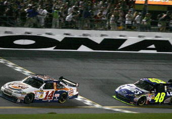 DAYTONA BEACH, FL - JULY 04: Tony Stewart, driver of the #14 Burger King Chevrolet, crosses the finish line ahead of Jimmie Johnson, drive of the #48 Lowe's Kobalt Tools Chevrolet, to win the NASCAR Sprint Cup Series 51st Annual Coke Zero 400 at Daytona International Speedway on July 4, 2009 in Daytona Beach, Florida.  (Photo by Jerry Markland/Getty Images for NASCAR)