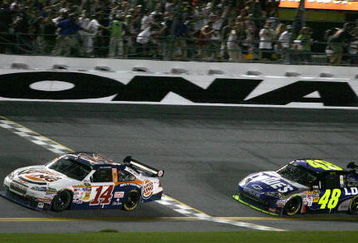 DAYTONA BEACH, FL - JULY 04: Tony Stewart, driver of the #14 Burger King Chevrolet, crosses the finish line ahead of Jimmie Johnson, drive of the #48 Lowe's Kobalt Tools Chevrolet, to win the NASCAR Sprint Cup Series 51st Annual Coke Zero 400 at Daytona International Speedway on July 4, 2009 in Daytona Beach, Florida.  (Photo by Jerry Markland/Getty Images for NASCAR)