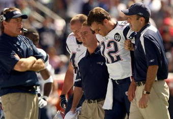 FOXBORO, MA - SEPTEMBER 7:  Quarterback Tom Brady #12 of the New England Patriots walks off the field with the aid of the Patriots staff after being injured on a play during their NFL game against the Kansas City Chiefs on September 7, 2008 at Gillette Stadium in Foxboro, Massachusetts. The Patriots defeated the Chiefs 17-10. (Photo by Elsa Garrison/Getty Images)