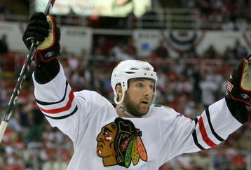DETROIT - MAY 19:  Cam Barker #25 of the Chicago Blackhawks celebrates after Jonathan Toews scored a goal to tie the game 2-2 in the third period against the Detroit Red Wings during Game Two of the Western Conference Championship Round of the 2009 Stanley Cup Playoffs on May 19, 2009 at Joe Louis Arena in Detroit, Michigan.  (Photo by Dave Sandford/Getty Images)