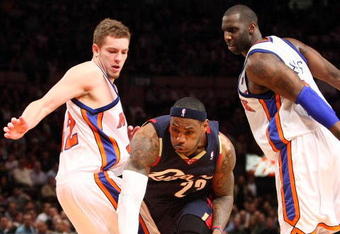 NEW YORK - FEBRUARY 04:  LeBron James #23 of the Cleveland Cavaliers dribbles past David Lee #42 and Tim Thomas #2 of the New York Knicks on February 4, 2009 at Madison Square Garden in New York City. NOTE TO USER: User expressly acknowledges and agrees that, by downloading and or using this photograph, User is consenting to the terms and conditions of the Getty Images License Agreement.  (Photo by Nick Laham/Getty Images)