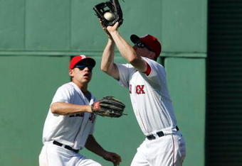 BOSTON - JULY 05:  J.D. Drew #7 of the Boston Red Sox makes the catch for the out as teammate Jacoby Ellsbury #46 looks on in the ninth inning against the Seattle Mariners on July 5, 2009 at Fenway Park in Boston, Massachusetts. The Red Sox defeated the Mariners 8-4.  (Photo by Elsa/Getty Images)