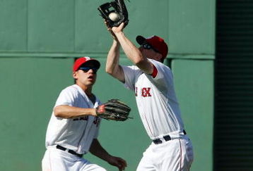 BOSTON - JULY 05:  J.D. Drew #7 of the Boston Red Sox makes the catch for the out as teammate Jacoby Ellsbury #46 looks on in the ninth inning against the Seattle Mariners on July 5, 2009 at Fenway Park in Boston, Massachusetts. The Red Sox defeated the Mariners 8-4.  (Photo by Elsa/Getty Images)