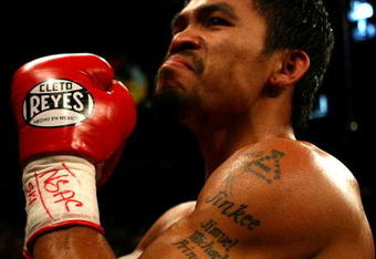 LAS VEGAS - MAY 02:  Manny Pacquiao of the Philippines celebrates after knocking down Ricky Hatton of England in the second round during their junior welterweight title fight at the MGM Grand Garden Arena May 2, 2009 in Las Vegas, Nevada.  (Photo by Al Bello/Getty Images)