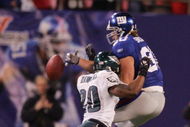 EAST RUTHERFORD, NJ - DECEMBER 17:  Jeremy Shockey #80 of the New York Giants can't come up with a reception as Brian Dawkins #20 of the Philadelphia Eagles defends on December 17, 2006 at Giants Stadium in East Rutherford, New Jersey. The Eagles defeated the Giants 36-22.  (Photo by Jim McIsaac/Getty Images)