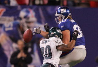 EAST RUTHERFORD, NJ - DECEMBER 17:  Jeremy Shockey #80 of the New York Giants can't come up with a reception as Brian Dawkins #20 of the Philadelphia Eagles defends on December 17, 2006 at Giants Stadium in East Rutherford, New Jersey. The Eagles defeated the Giants 36-22.  (Photo by Jim McIsaac/Getty Images)