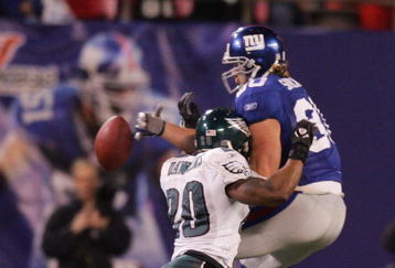 EAST RUTHERFORD, NJ - DECEMBER 17:  Jeremy Shockey #80 of the New York Giants can't come up with a reception as Brian Dawkins #20 of the Philadelphia Eagles defends on December 17, 2006 at Giants Stadium in East Rutherford, New Jersey. The Eagles defeated the Giants 36-22.  (Photo by Jim McIsaac/Getty Images)