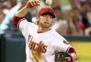 PHOENIX - APRIL 22:  Infielder Mark Reynolds #27 of the Arizona Diamondbacks juggles the ball after attempting to field a foul ball against the Colorado Rockies during the game at Chase Field on April 22, 2009 in Phoenix, Arizona. The Diamondbacks defeated the Rockies 2-0. (Photo by Christian Petersen/Getty Images)