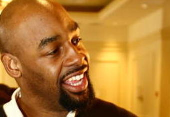TAMPA, FL - JANUARY 31: Philadelphia Eagles quarterback Donovan McNabb plays with the ID Coach Wristband  at the launch of the Isaac Daniel, ID Coach at the Sheraton Riverwalk on January 31, 2009 in Tampa, Florida. The ID Coach system allows coaches to communicate plays to players without using hand signals or audio transmitters. Play calls are transmitted using a military grade encrypted wireless link from the coaches Personal Remote Terminal (PRT) to the assigned player on the field who recieves the play on the ID Coach wristband.  (Photo by Chris McGrath/Getty Images for EAG Sports Management)