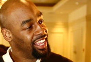TAMPA, FL - JANUARY 31: Philadelphia Eagles quarterback Donovan McNabb plays with the ID Coach Wristband  at the launch of the Isaac Daniel, ID Coach at the Sheraton Riverwalk on January 31, 2009 in Tampa, Florida. The ID Coach system allows coaches to communicate plays to players without using hand signals or audio transmitters. Play calls are transmitted using a military grade encrypted wireless link from the coaches Personal Remote Terminal (PRT) to the assigned player on the field who recieves the play on the ID Coach wristband.  (Photo by Chris McGrath/Getty Images for EAG Sports Management)