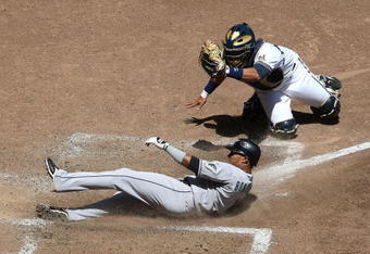 MILWAUKEE - MAY 14: Mike Rivera #11 of the Milwaukee Brewers shows the ball to the umpire after tagging out Emilio Bonifacio #1 of the Florida Marlins in the 5th inning on May 14, 2009 at Miller Park in Milwaukee, Wisconsin. The Brewers defeated the Marlins 5-3. (Photo by Jonathan Daniel/Getty Images)