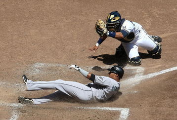 MILWAUKEE - MAY 14: Mike Rivera #11 of the Milwaukee Brewers shows the ball to the umpire after tagging out Emilio Bonifacio #1 of the Florida Marlins in the 5th inning on May 14, 2009 at Miller Park in Milwaukee, Wisconsin. The Brewers defeated the Marlins 5-3. (Photo by Jonathan Daniel/Getty Images)