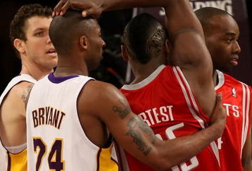 LOS ANGELES, CA - MAY 17:  Kobe Bryant #24 of the Los Angeles Lakers and Ron Artest #96 of the Houston Rockets get twisted up in the second quarter of Game Seven of the Western Conference Semifinals during the 2009 NBA Playoffs at Staples Center on May 17, 2009 in Los Angeles, California. NOTE TO USER: User expressly acknowledges and agrees that, by downloading and or using this photograph, User is consenting to the terms and conditions of the Getty Images License Agreement.  (Photo by Stephen Dunn/Getty Images)