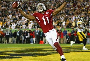 TAMPA, FL - FEBRUARY 01:  Larry Fitzgerald #11 of the Arizona Cardinals celebrates after scoring a touchdown in the fourth quarter against the Pittsburgh Steelers during Super Bowl XLIII on February 1, 2009 at Raymond James Stadium in Tampa, Florida.  (Photo by Al Bello/Getty Images)