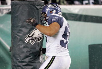 PHILADELPHIA - DECEMBER 05:  Lofa Tatupu #51 of the Seattle Seahawks celebrates his touchdown in the second quarter by punching the goal post during the game against the Philadelphia Eagles giving the Seahawks a 21-0 lead on December 5, 2005 at Lincoln Financial Field in Philadelphia, Pennsylvannia.  (Photo by Jamie Squire/Getty Images)